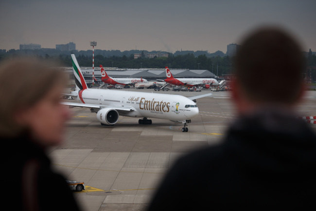 A passenger aircraft operated by Emirates is seen at Dusseldorf Airport on Wednesday.   Bloomberg