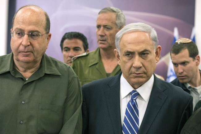 Israeli Prime Minister Benjamin Netanyahu (right) leaves after delivering a statement in Tel Aviv on Saturday.   AFP-Yonhap