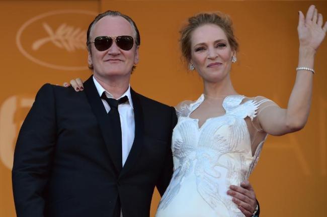 U.S. director Quentin Tarantino, who says digital film-making spells the death of traditional cinema, poses with actress Uma Thurman at the Cannes Film Festival on May 24, 2014.   AFP
