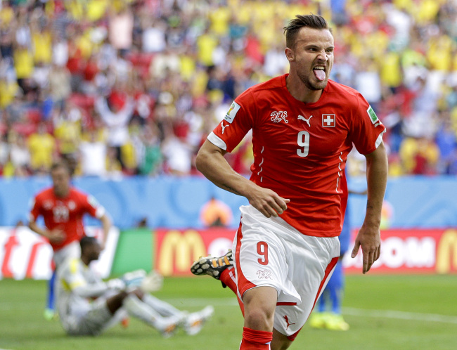 Haris Seferovic scored in the last minute of injury time to grab Switzerland a dramatic 2-1 win over Ecuador in their Group E game at the World Cup finals in Brasilia on Sunday.