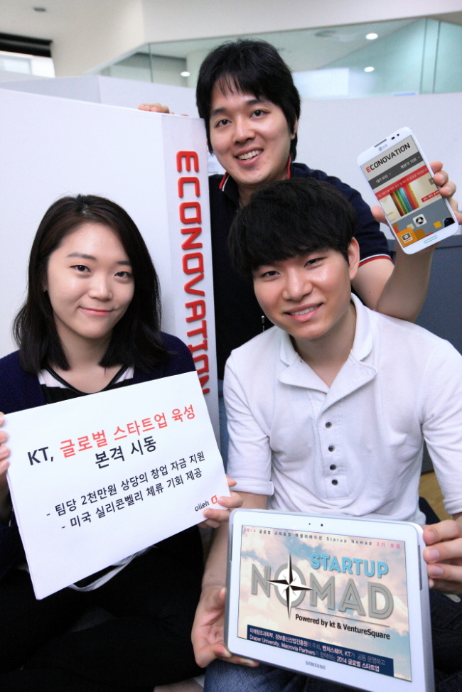 KT officials pose at the firm’s startup incubation center, called Econovation, in Seoul on Monday.   KT