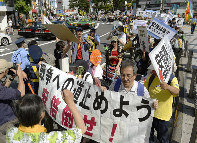 Protesters demonstrate against the Shinzo Abe administration’s push for the right to exercise collective self-defense on Sunday. Organizers say some 500 people took part in the event.   Yonhap