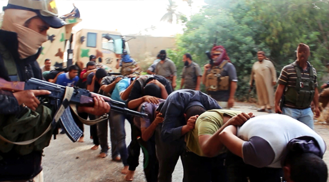 This image posted on a militant website on Saturday appears to show militants from the al-Qaida-inspired Islamic State of Iraq and the Levant leading away captured Iraqi soldiers dressed in plain clothes after taking over a base in Tikrit, Iraq.    AP-Yonhap