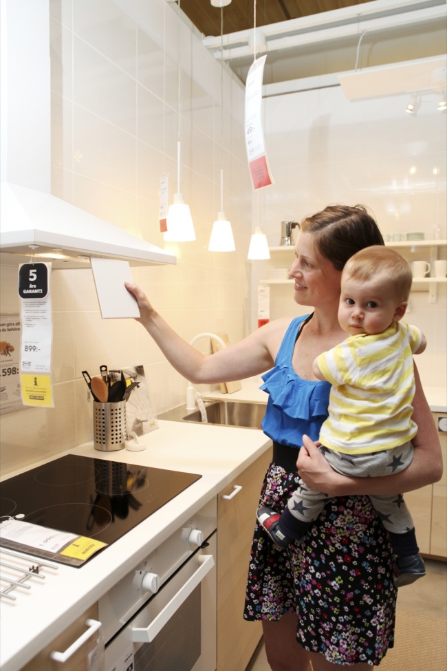 Elin Stiona, an Ikea customer, looks over a cupboard at an Ikea outlet in Almhult, Sweden.   Ikea Korea