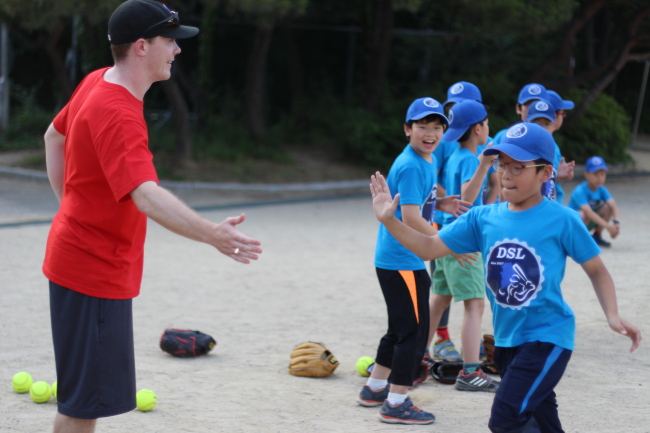Children and volunteers participate in a softball competition run by Daegu Softball league in partnership with a local orphanage.   Jeff Molasky