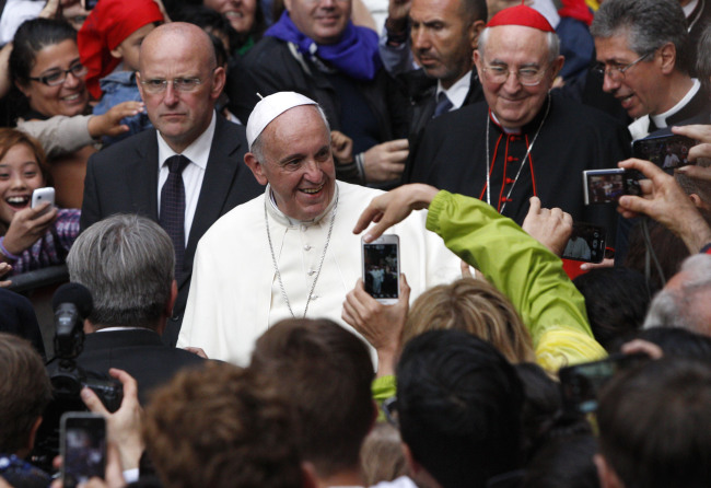 Pope Francis greets faithful as he arrives for a meeting with members of a Catholic organization, Sant’Egidio Community, in Rome, Sunday.   AP-Yonhap