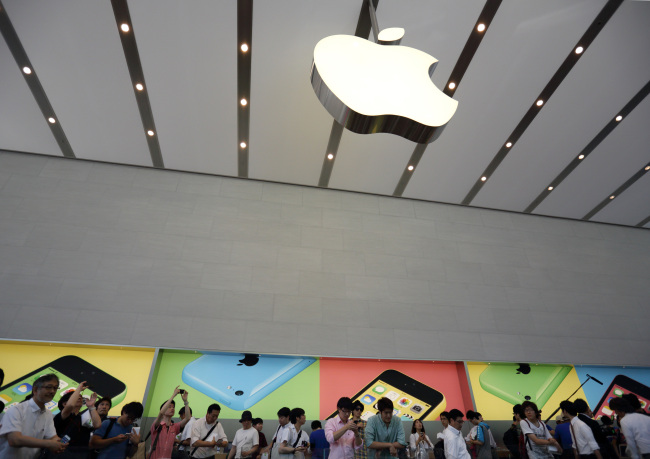Customers browse inside the company’s Omotesando store in Tokyo.   Bloomberg