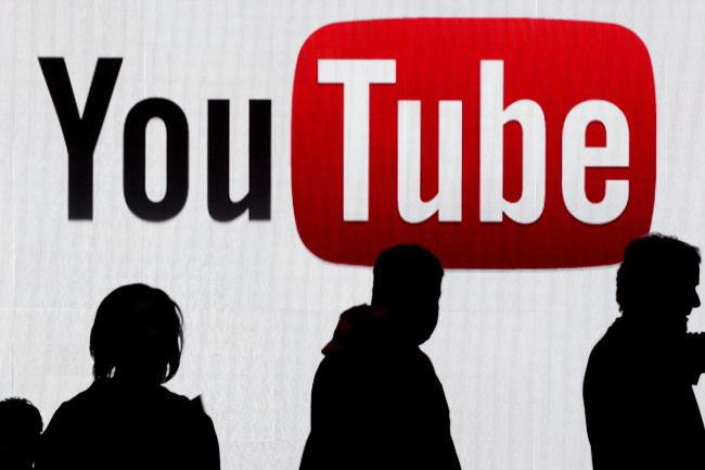 Attendees walk past the YouTube logo at the International Consumer Electronics Show in Las Vegas.  Bloomberg