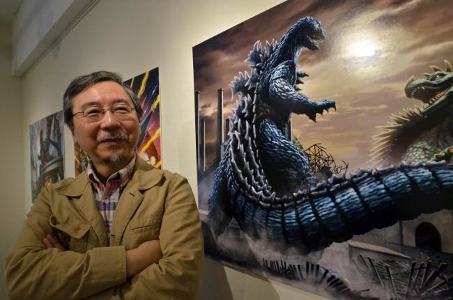 Japanese artist Yuji Kaida speaks at his exhibition in Tokyo showing drawings of Godzilla on May 4.   AFP-Yonhap