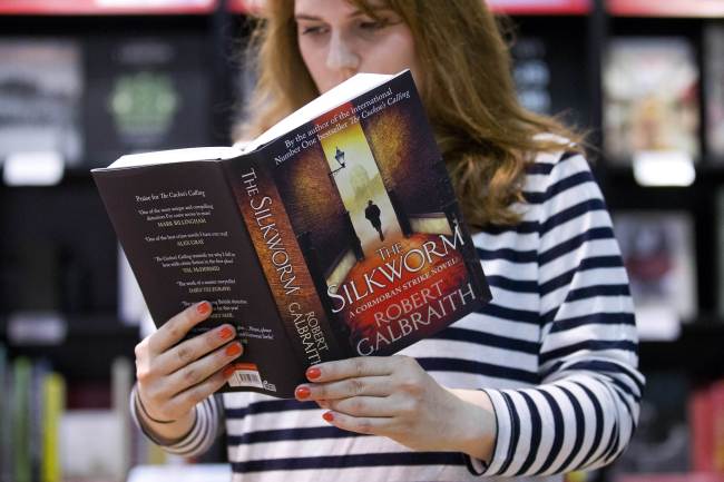 An employee of Waterstones poses with a copy of “The Silkworm” by author Robert Galbraith, aka Harry Potter author J.K. Rowling, as it goes on sale for the first time at a bookshop in London on Thursday.  AFP-Yonhap