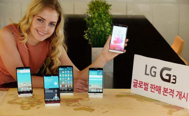 A model poses with LG Electronics’ G3 smartphones embedded with LG Innotek’s camera modules powering its optical image stabilizer, dual-LED flash and laser auto focus. LG G3 hits global markets on Tuesday.   LG Electronics