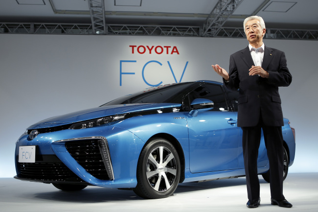 Mitsuhisa Kato, executive vice president at Toyota Motor, speaks as he introduces the company’s fuel cell vehicle during a news conference in Tokyo on Wednesday.  Bloomberg