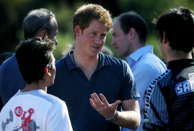 Prince Harry chats with trail bike riders during a visit to the Antaeaya outdoor center in Santiago on Sunday.   AFP-Yonhap