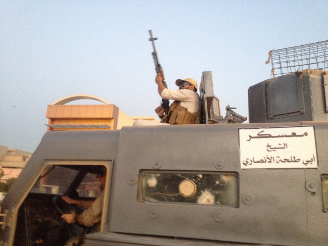 Fighters of the al-Qaida-inspired Islamic State of Iraq and the Levant parade in a commandeered Iraqi security forces armored vehicles down a main road at the northern city of Mosul, Iraq, more than two weeks after ISIL took over the country’s second-largest city.   AP-Yonhap