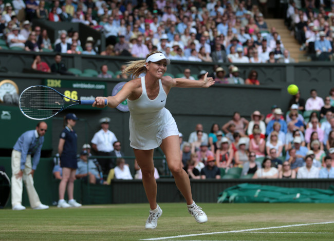 Maria Sharapova returns a shot against Angelique Kerber at Wimbledon on Tuesday.   UPI-Yonhap