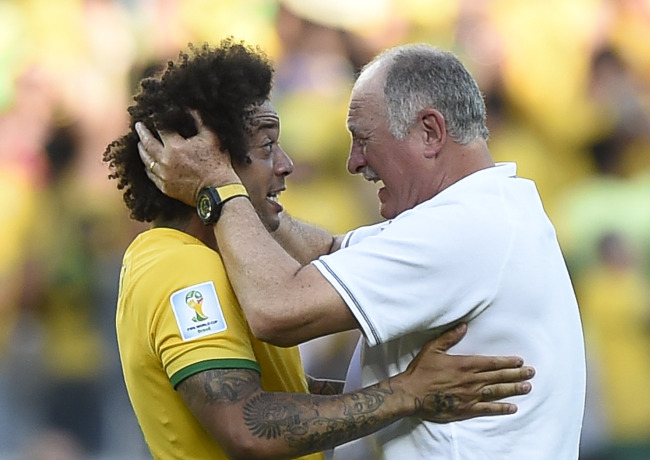 Brazil’s head coach Luiz Felipe Scolari (right) and David Luiz celebrate their win over Chile in the Round of 16.   Xinhua-Yonhap