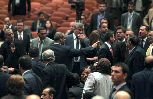 Shiite Muslim MP Kadhim al-Sayadi, a lawmaker in Prime Minister Nuri al-Maliki’s bloc, points a finger as he argues with Kurdish deputies during the first parliamentary session following Iraq’s national elections in Baghdad on Tuesday.   AFP-Yonhap