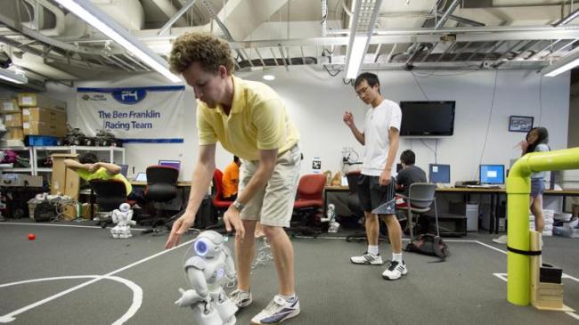Ph.D. candidate Stephen McGill works with a Nao RoboCup entry at the
University of Pennsylvania in Philadelphia on July 7. (AP)