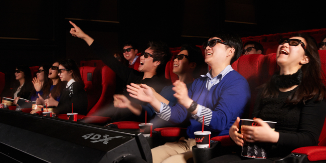 Audiences enjoy a 4-DX film. CJ 4DPLEX