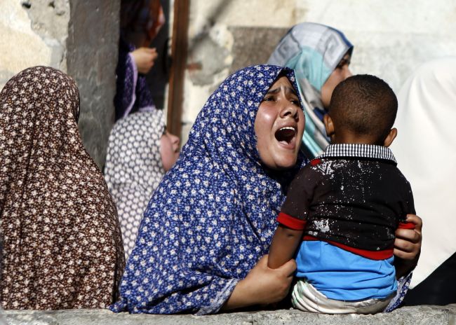 Relatives of four boys, all from the Bakr family, mourn during their funeral in Gaza City on  Wednesday.   AfP-Yonhap