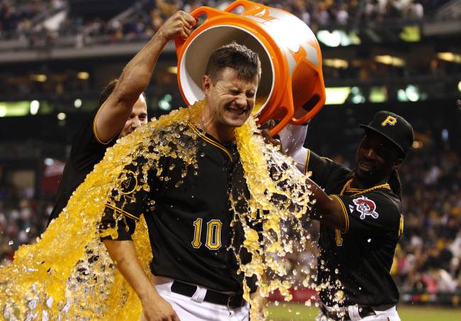 Andrew McCutchen (right) and Gaby Sanchez (left) dump Gatorade on Jordy Mercer of the Pittsburgh Pirates after hitting a walk-off double in the 11th inning against the Colorado Rockies at PNC Park on Saturday.   (AFP-Yonhap)