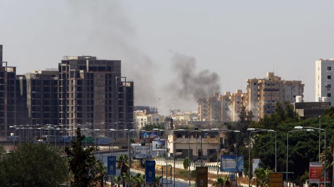 Smoke billows from the site of clashes on the road leading to the airport in Tripoli on Sunday.   AFP-Yonhap