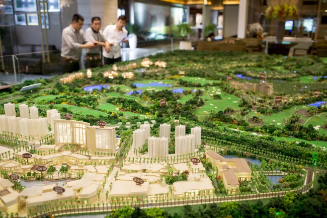 A scale model of the Mission Hills Lan Kwai Fong development and residential properties stands on display in a showroom at Mission Hills Resort Haikou in Haikou, Hainan province, China.   Bloomberg