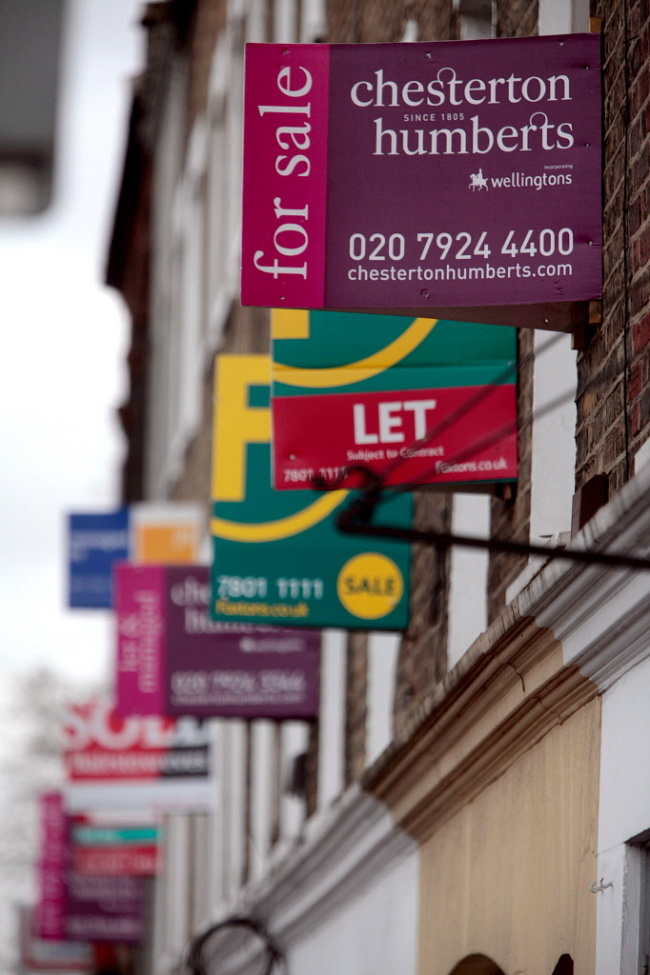 Estate agents’ signs advertising residential properties for sale are seen in Brixton, London.   Bloomberg