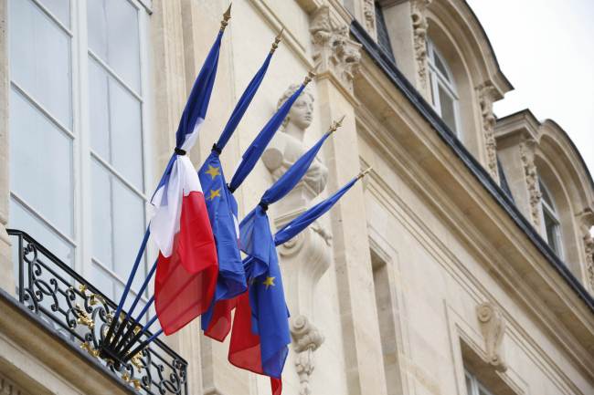 Black ribbons are tied around French and EU flags at the Elysee Palace in Paris on Monday.   AP-Yonhap