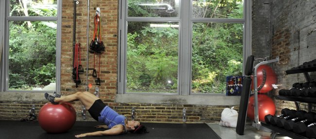 Stephanie Miller works out at Activate Body Potential, a boutique gym, in the Clipper Mill business area of Baltimore on July 18.   Baltimore Sun/MCT