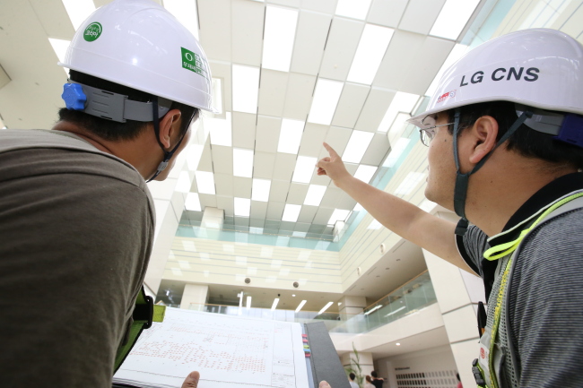 LG CNS officials inspect the company’s smart lighting system installed at LG Display’s plant in Paju, Gyeonggi Province. (LG CNS)