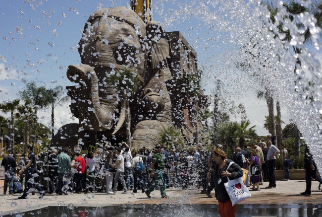 Journalists gather in front of a gigantic elephant statue, part of the adventurous family ride “Erawan — The Lost Temple,” a
54-meter drop tower, at the Cinecitta World theme park on the outskirts of Rome on July 10. (AP-Yonhap)