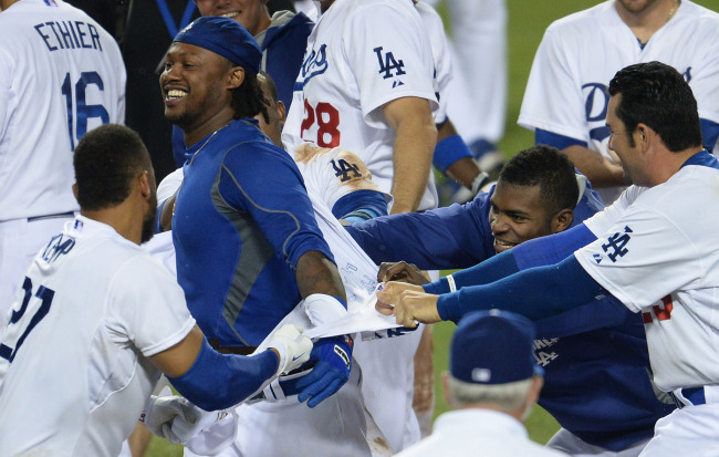 Los Angeles Dodgers shortstop Hanley Ramirez (second from left) gets his jersey ripped off by teammates after hitting a walkoff three-run home run on Saturday.    USA TODAY-Yonhap