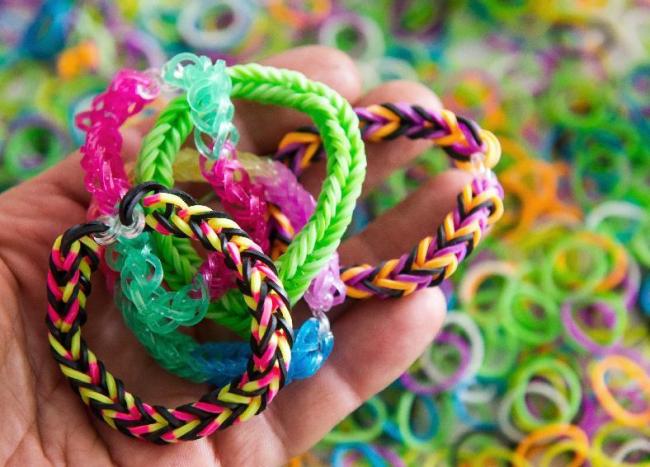 Loom bands — colorful rubber bands woven together into bracelets and other items — are the latest craze to sweep playgrounds everywhere from New York to Singapore. (AFP)
