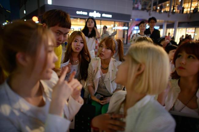Manager Park In-seo (second from left) talks to K-pop group Billion members Ki-Ryeon (left), Janet (center from left), Betty (center from right) and Seul-gi (right) prior to a performance at a shopping mall in Ilsan near Seoul on June 10.   AFP