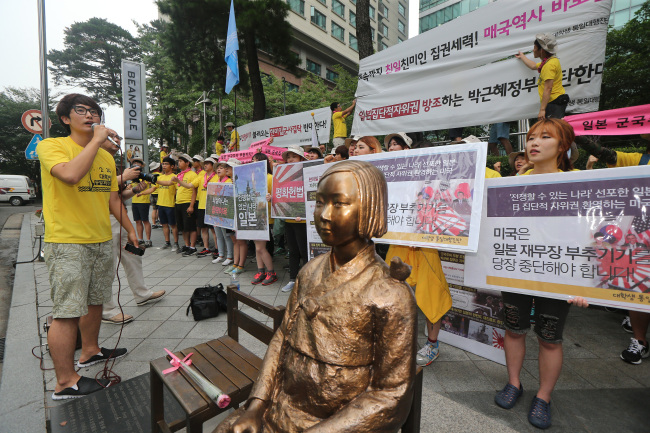 University students protest Japan’s defense policies outside the Japanese Embassy in Seoul on Tuesday.   Yonhap