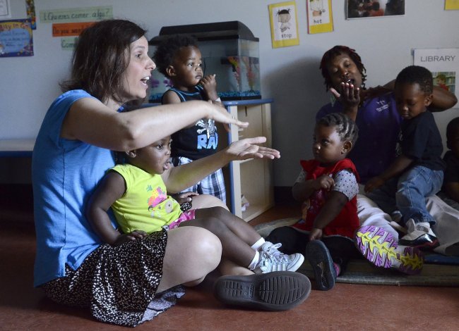 Jessica McQuillen, an art teacher at the Thompson Center for Child Development, leads a group song on June 4.   Charlotte Observer/MCT