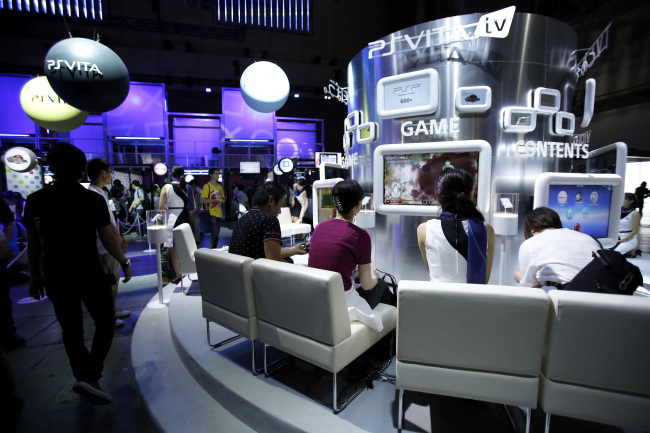 Attendees play video games on Sony Computer Entertainment Inc. PlayStation Vita TV (PS Vita TV) console at the Tokyo Game Show 2013 in Chiba, Japan. (Bloomberg)