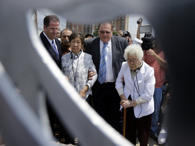 Lee Ok-sun (right), 87, and Kang Il-chul, 86, stand at the dedication of a monument to comfort women, the Asian women who were forced into prostitution during World War II, on Monday, in Union City. (AP-Yonhap)