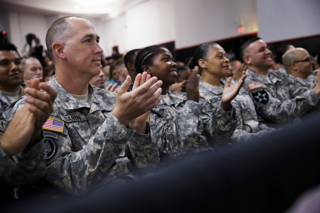 Members of the military applaud as President Barack Obama speaks about H.R. 3230, the Veterans’ Access to Care through Choice, Accountability, and Transparency Act of 2014, Thursday, at the Wallace Theater in Fort Belvoir, Virgina, U.S. (AP)