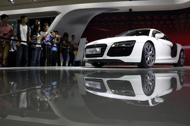 Visitors look at an Audi R8 vehicle at the Wuhan Motor Show in Wuhan, China.   Bloomberg
