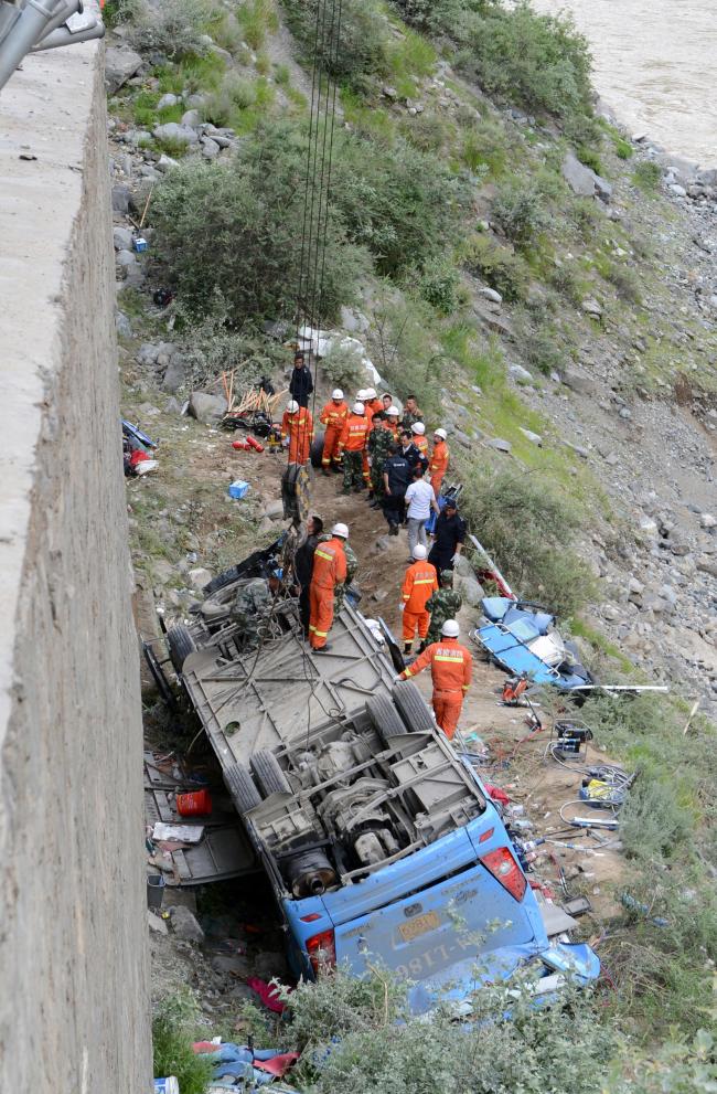 Rescuers work near an overturned bus in Nyemo County, Tibet Autonomous Region, China, Saturday.   Xinhua-Yonhap
