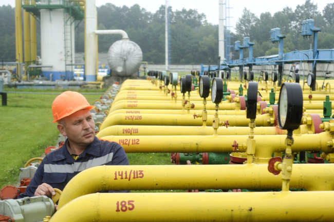 An employee adjusts a control wheel on pipework at the Dashava underground gas storage facility in Lviv, Ukraine.   Bloomberg