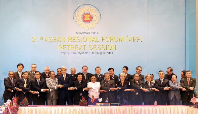 Foreign ministers join hands for a photocall during a ceremony to launch the logo for the ASEAN Regional Forum Disaster Relief Exercises at the Myanmar International Convention Center in Naypyitaw on Sunday.   Yonhap