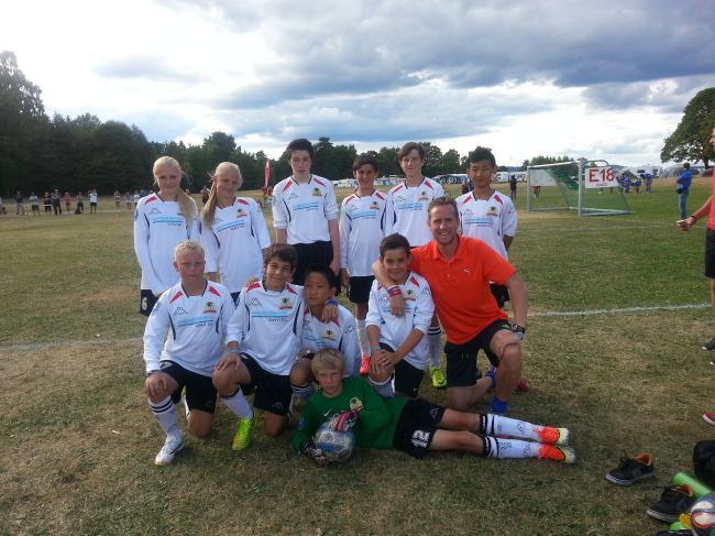 The Rising Star Football Academy’s Norway Cup team poses for a group photo. From left, back row: Anna Sandvik Gloppen, Marte Nodset, Olly Corfield, Jack Cook, Tobias Fauske and Taewoo Kim. From left, front row:  Anita Eek, Kaua Leite, Eugene Park, Rasmus Wend Sandgren and coach James McAloon. In front is goalkeeper Gustaf Malo.   RSFA