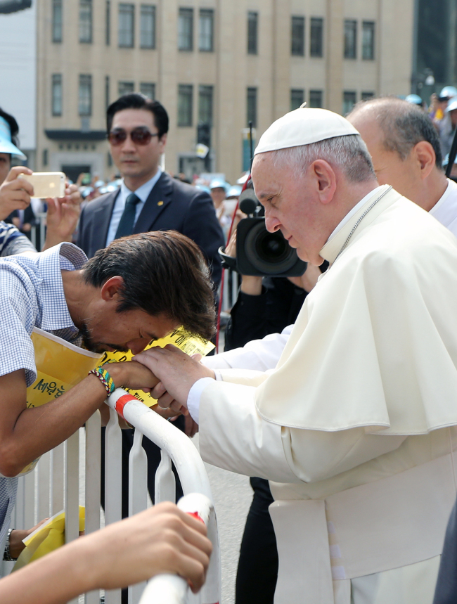 Pope Francis consoles the father of a victim of the Sewol ferry disaster, who has been on hunger strike for more than a month demanding an independent investigation of the accident.   Committee for the Papal Visit to Korea
