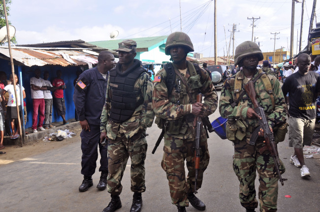 Liberian soldiers patrol in the West Point area as the government clamps down on the movement of people to prevent the spread of the Ebola virus in Monrovia on Wednesday.   AP-Yonhap