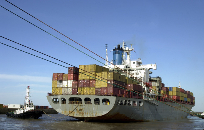 A ship laden with cargo containers prepares to leave the port of Buenos Aires, Argentina.   Bloomberg