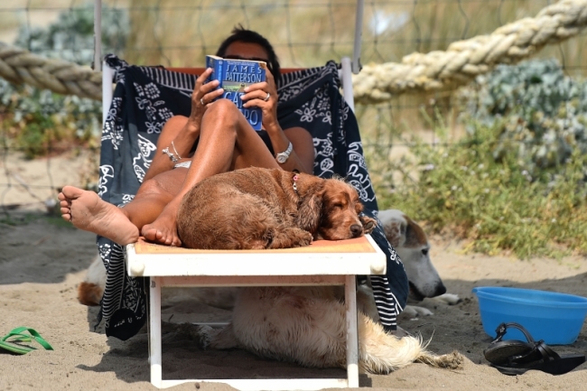 A woman and her dogs rest at Baubeach in Maccarese, near Rome. (AFP)