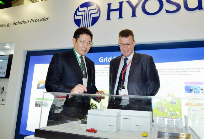 Hyosung Corp. president Cho Hyun-joon (left) talks to Frederic Salon, regional commercial vice president for the East Asia Pacific of ALSTOM, at the Conseil International des Grands Reseaux Electriques, which runs in Paris until Friday.   Hyosung Corp